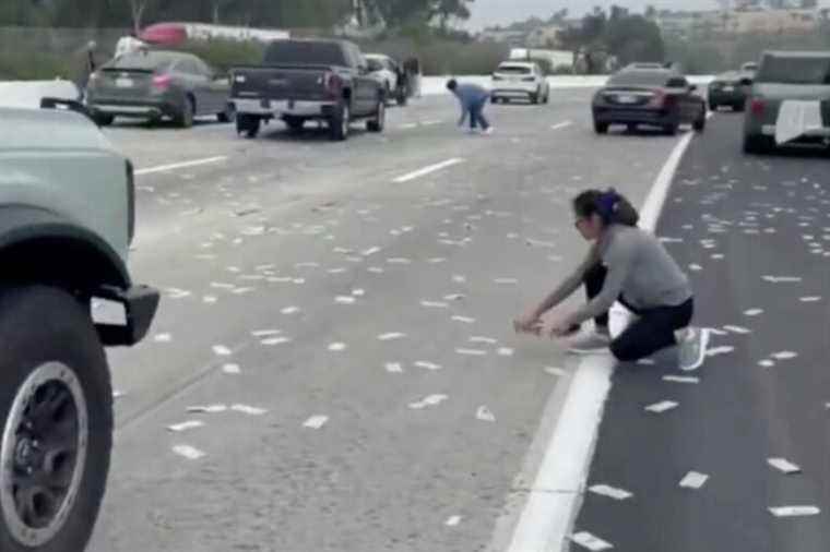 The door of an armored van opens in the middle of the highway