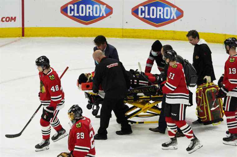 Chicago Blackhawks |  Jujhar Khaira leaves the ice on a stretcher