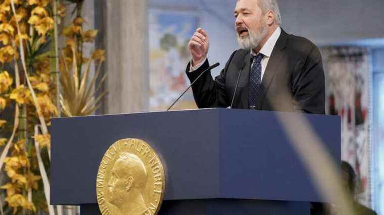 Nobel Peace Prize winner Dimitri Muratov points to Yves Rocher