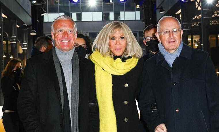 Brigitte Macron radiant in a long black coat alongside Didier Deschamps for the launch of Operation Yellow Pieces