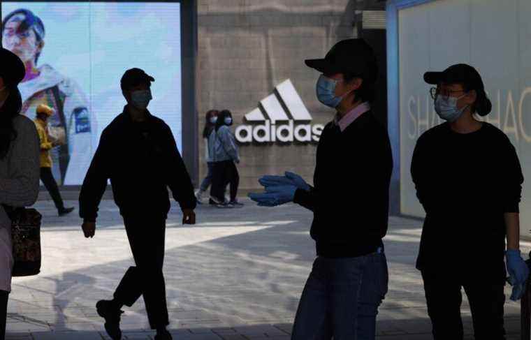 Adidas sparks controversy with topless ad