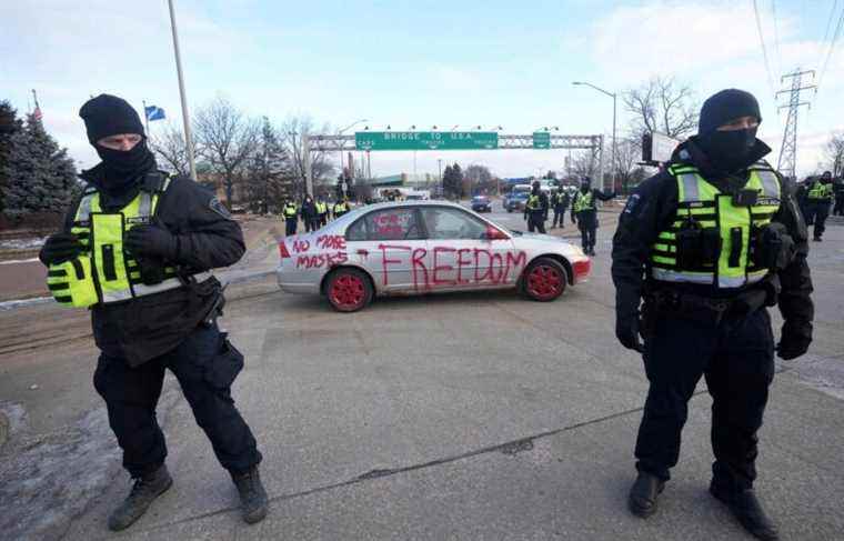 Police position themselves to evacuate the border bridge in Windsor