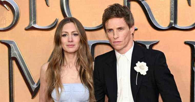 Eddie Redmayne on the arm of his wife, very bearded Jude Law at the premiere of Fantastic Beasts