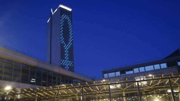 How is the Rouen archives tower illuminated each evening?