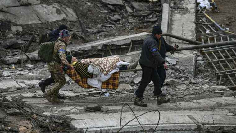 a bombed building in Kyiv as talks are due to resume on Monday morning