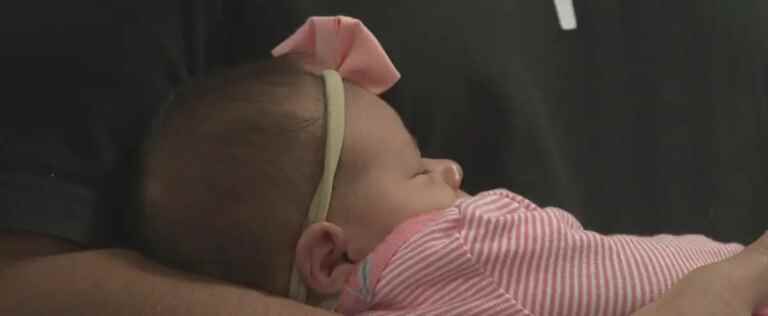 A paramedic helps a woman give birth on her first day at work