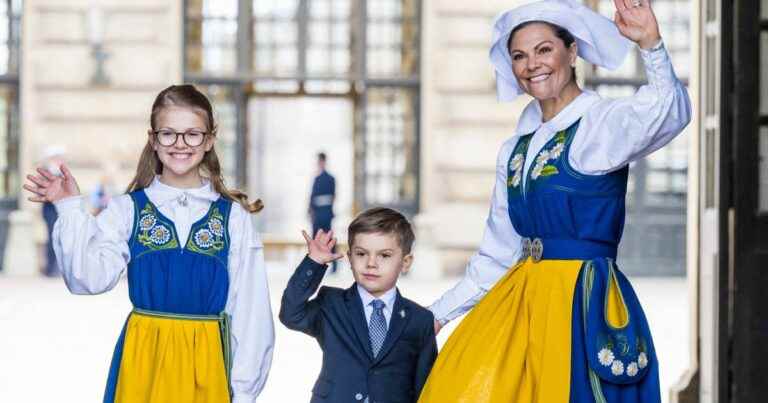 Victoria of Sweden in traditional dress with daughter Estelle while Oscar… yawns in boredom!