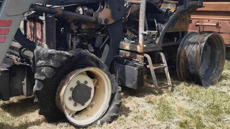 A mover prevents a tractor fire from reaching a wood