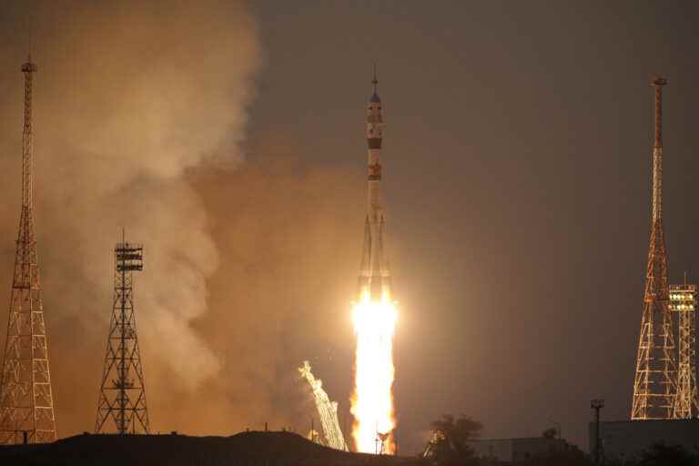 A Soyuz rocket takes off with an American and two Russians on board