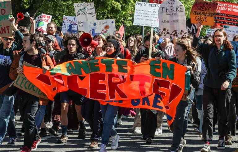 Environment Minister Benoit Charette, booed, left climate march