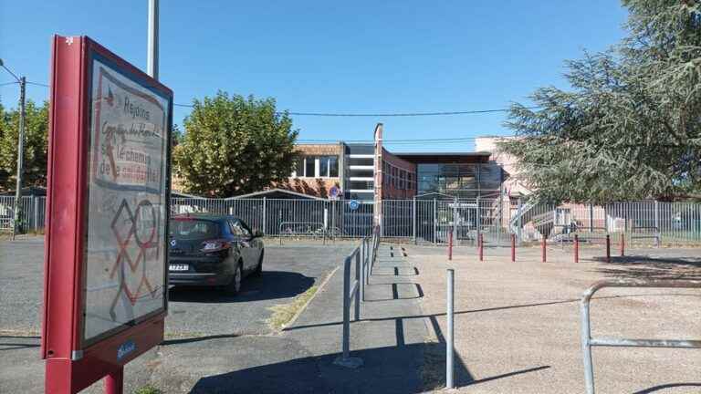 an advertisement for alcohol questions in front of a college in Bergerac