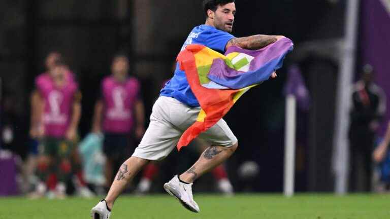 a man with a rainbow flag enters the pitch during the match Portugal-Uruguay