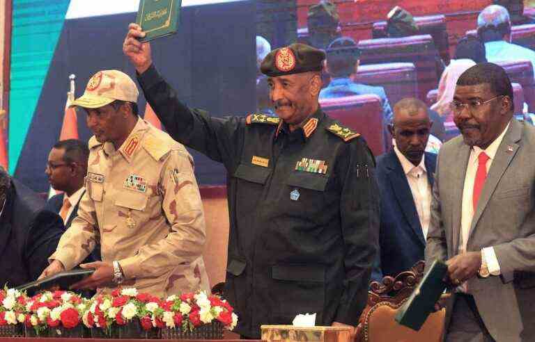 Soldiers and civilians sign an agreement to end the crisis in Sudan