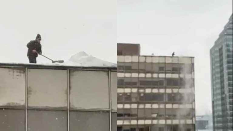 A man removes snow (without protection) from the roof of a building in downtown Montreal