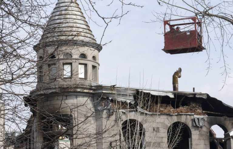 A second crane brought in to reinforce the burned building in Place D’Youville