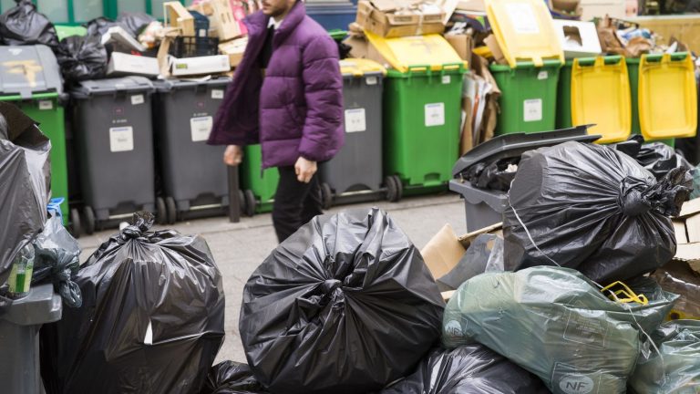 union activists throw trash cans against Renaissance party headquarters in Paris