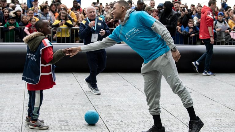 the emotion of Kylian Mbappé playing football with sick or struggling children at the Stade de France