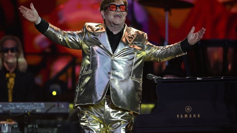 Elton John gets a standing ovation at the legendary Glastonbury Festival for his last UK concert of his farewell tour