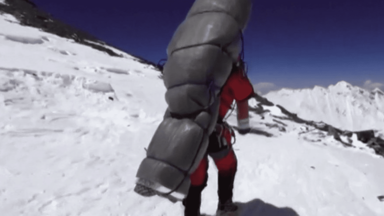 a Sherpa saves the life of a mountaineer in distress during the ascent of Everest