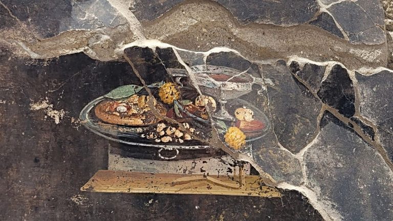 a painting of “pizza” discovered on a fresco in the ruins of the Roman city