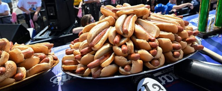 Even the rain can’t defeat Joey Chestnut at the annual Hot Dog Eaters’ High Mass