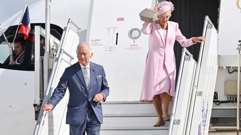 Camilla Parker Bowles struggles to hold her hat on and comes close to having a clothing accident!