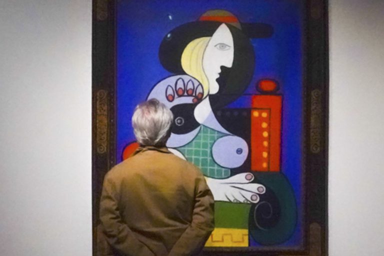 Woman with Picasso’s watch on display before its auction