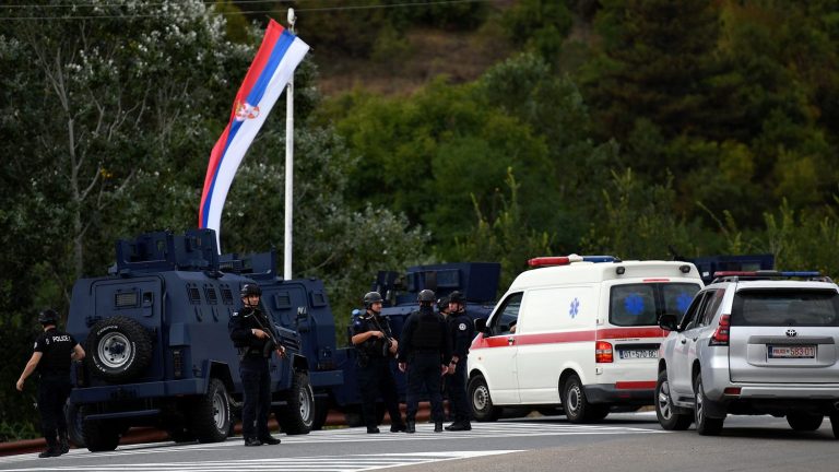 a police officer killed near the border with Serbia, armed men holed up in a monastery