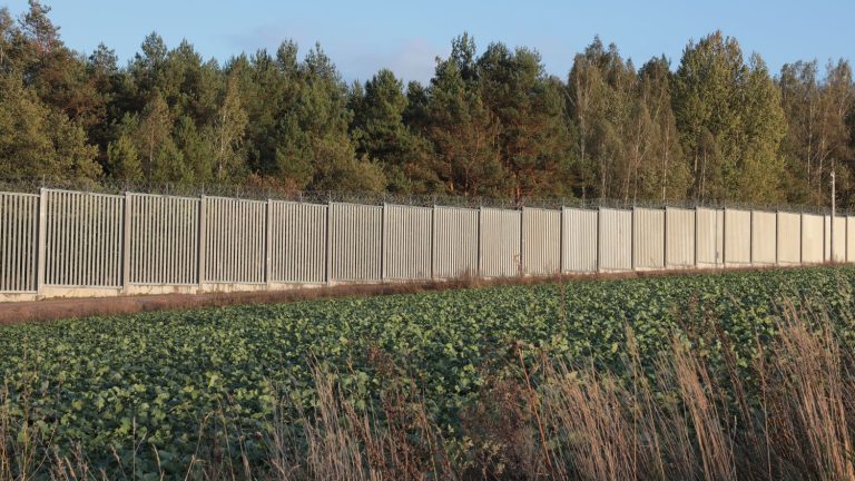 on the border with Belarus, a long wall poses one more danger on the exiles’ route