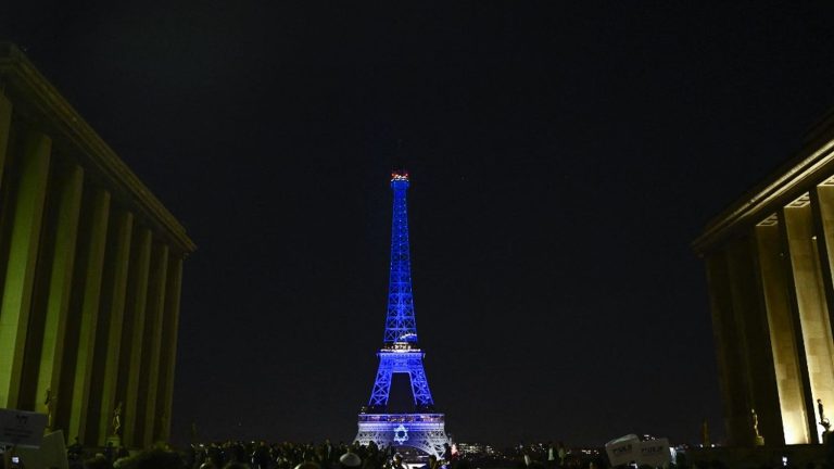 the Eiffel Tower lit up in the colors of Israel