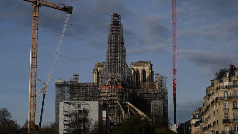 The scaffolding around the spire of Notre-Dame rises into the Paris sky