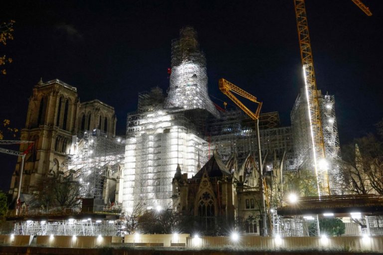 The silhouette of the Notre-Dame spire visible in the sky