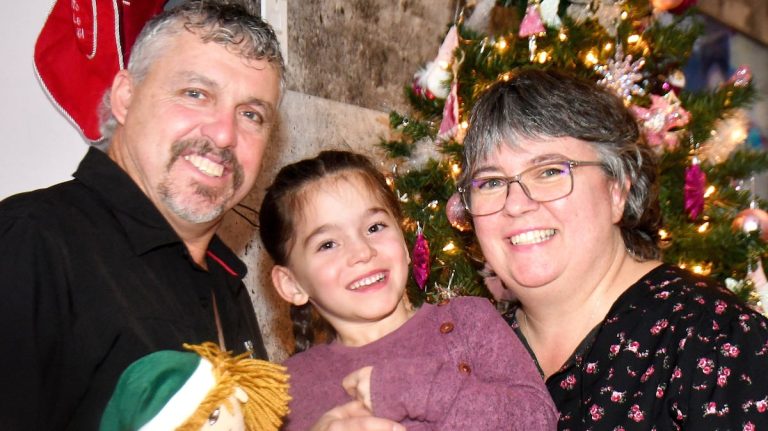 A couple who adopted an abandoned and seriously ill little girl are filled with joy