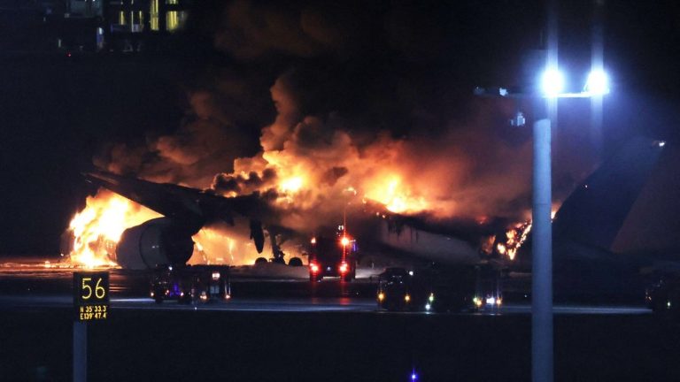 a passenger plane catches fire on a runway at Tokyo-Haneda airport