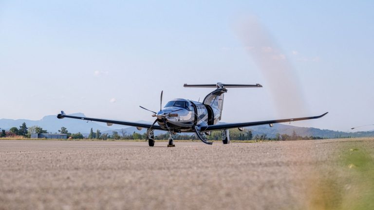 a small plane lands on a runway without landing gear after damage