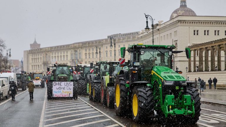 angry over plan to remove tax benefits, farmers and their tractors block central Berlin