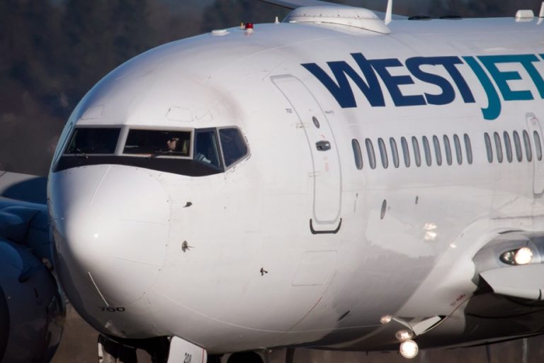 A passenger tries to open the door |  WestJet flight makes unscheduled stopover in Winnipeg