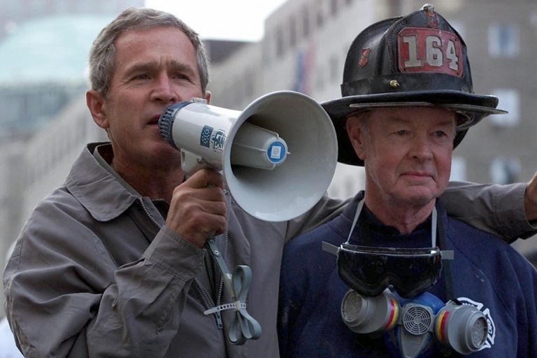 Bush salutes the memory of a firefighter at his side after September 11