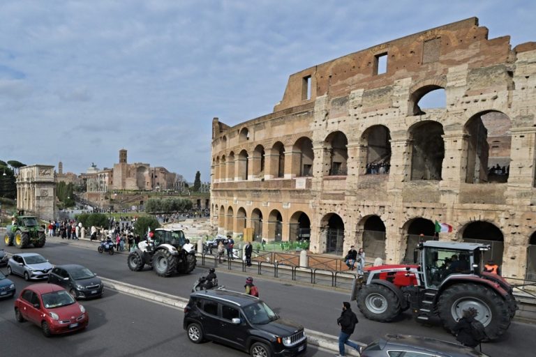 Italy |  Farmers parade tractors along the Colosseum