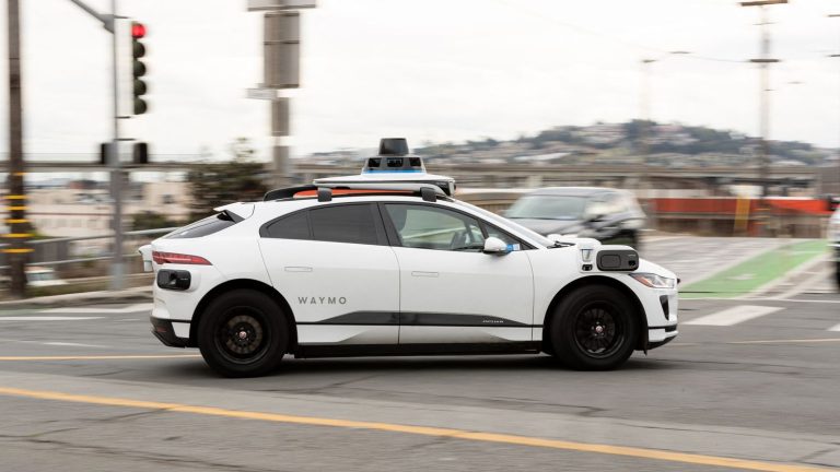 an autonomous Waymo taxi from the Alphabet group vandalized and set on fire in the middle of the street in San Francisco