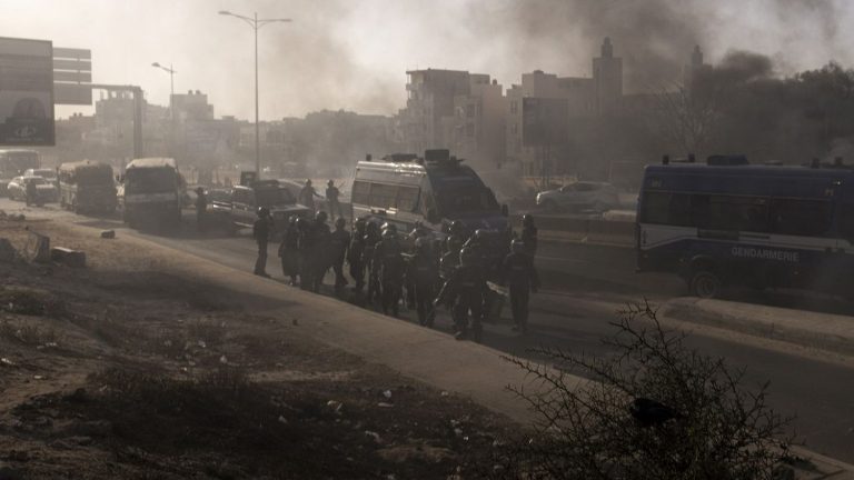 gendarmes disperse a gathering in front of the Assembly in Dakar with tear gas