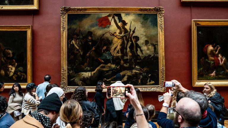 Delacroix’s famous painting “Liberty Leading the People” hung up in the Louvre after its restoration