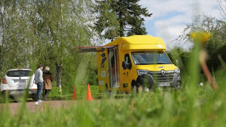 a Post Office truck crisscrosses the roads against the desert of public services