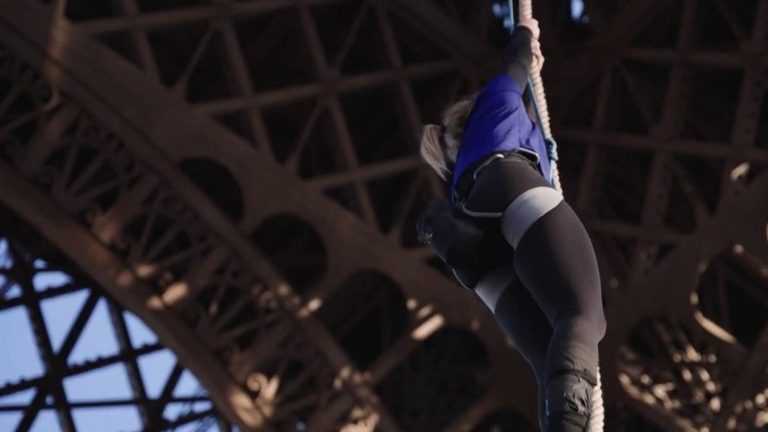 champion Anouk Garnier reaches the second floor of the Eiffel Tower in 18 minutes on the rope