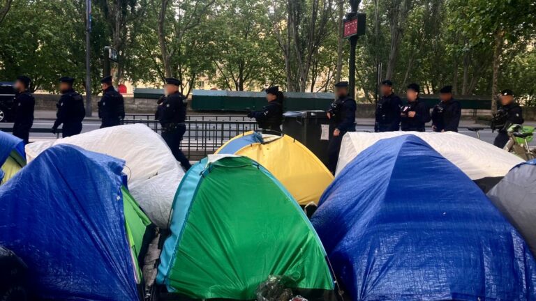 A hundred young migrants evacuated from a camp near the Seine in Paris on Tuesday morning