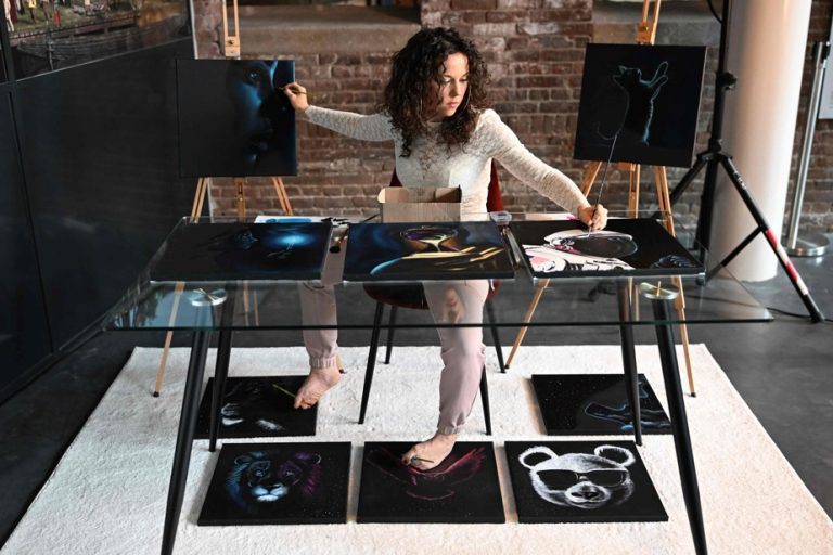 An artist paints ten paintings simultaneously with her hands and feet