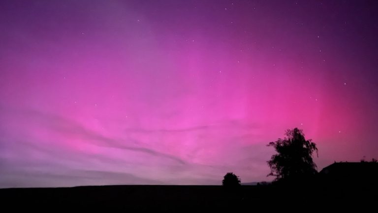 Magical night across France, with fascinating pink-tinted Northern Lights