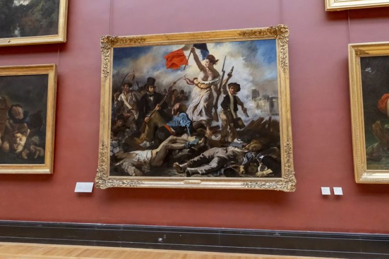 at the Louvre, posters stuck near the painting “Liberty leading the people”