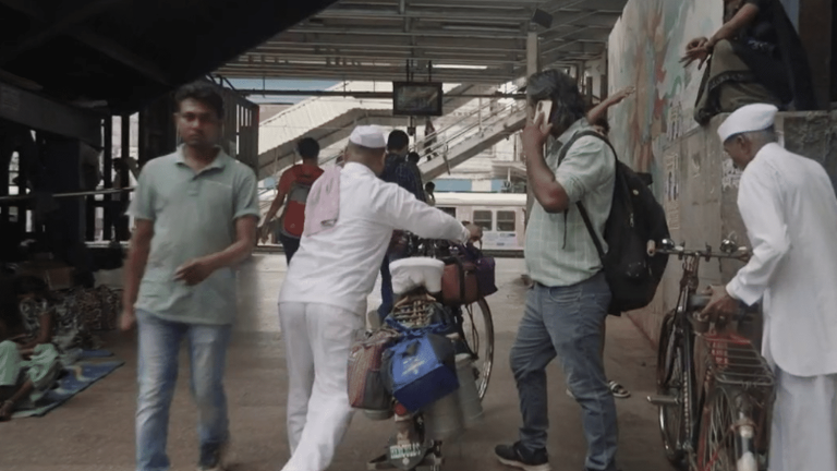 in Bombay, dabbawalas roam the streets delivering meals