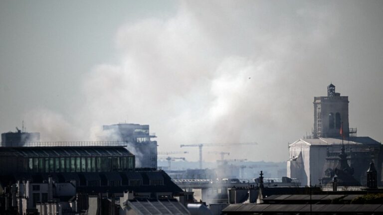 a fire is underway in a building near city hall, five firefighters injured and one person missing